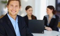 Portrait of a young man in front of a workgroup